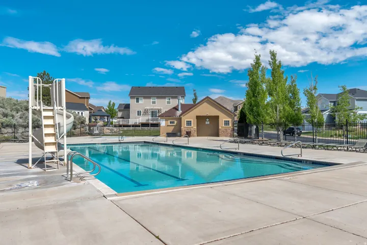 Expansive rectangular swimming pool with integrated steps, surrounded by a concrete deck