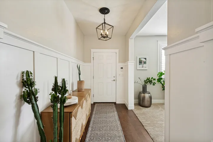 Entryway featuring a vaulted ceiling and board and batten wainscoting