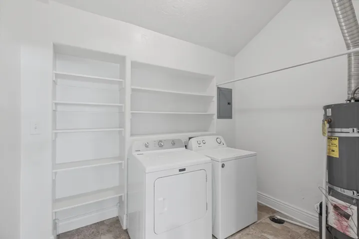 Built-in shelving for storage, tiled flooring, and a water heater
