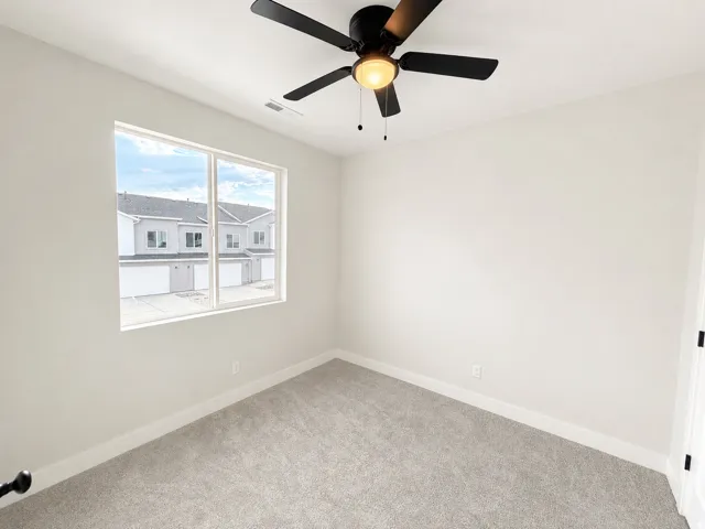 Neutral tone wall paint, light-toned carpet flooring, white trim, recessed lighting, and a modern ceiling fan
