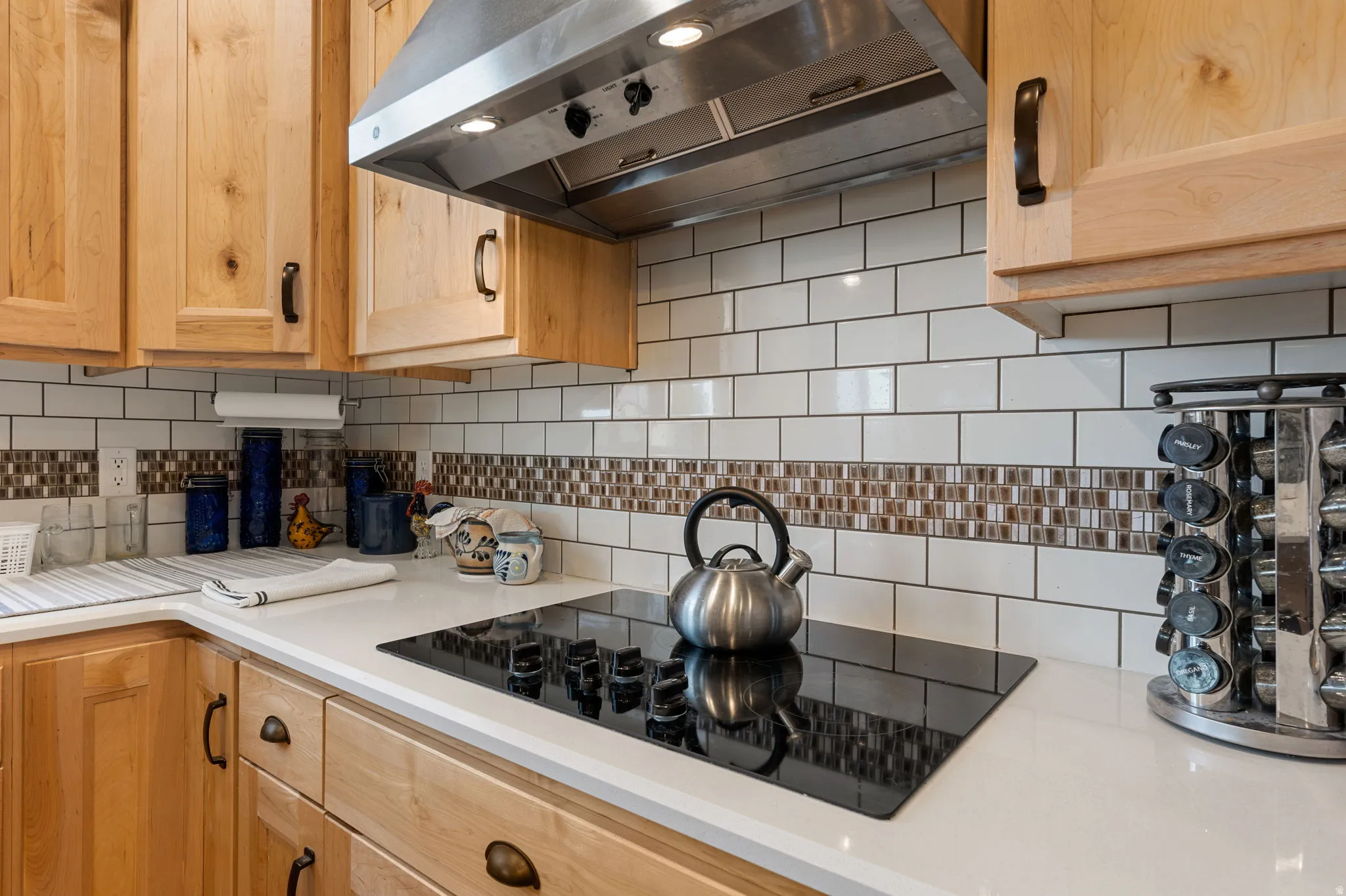 Natural wood cabinetry with dark hardware