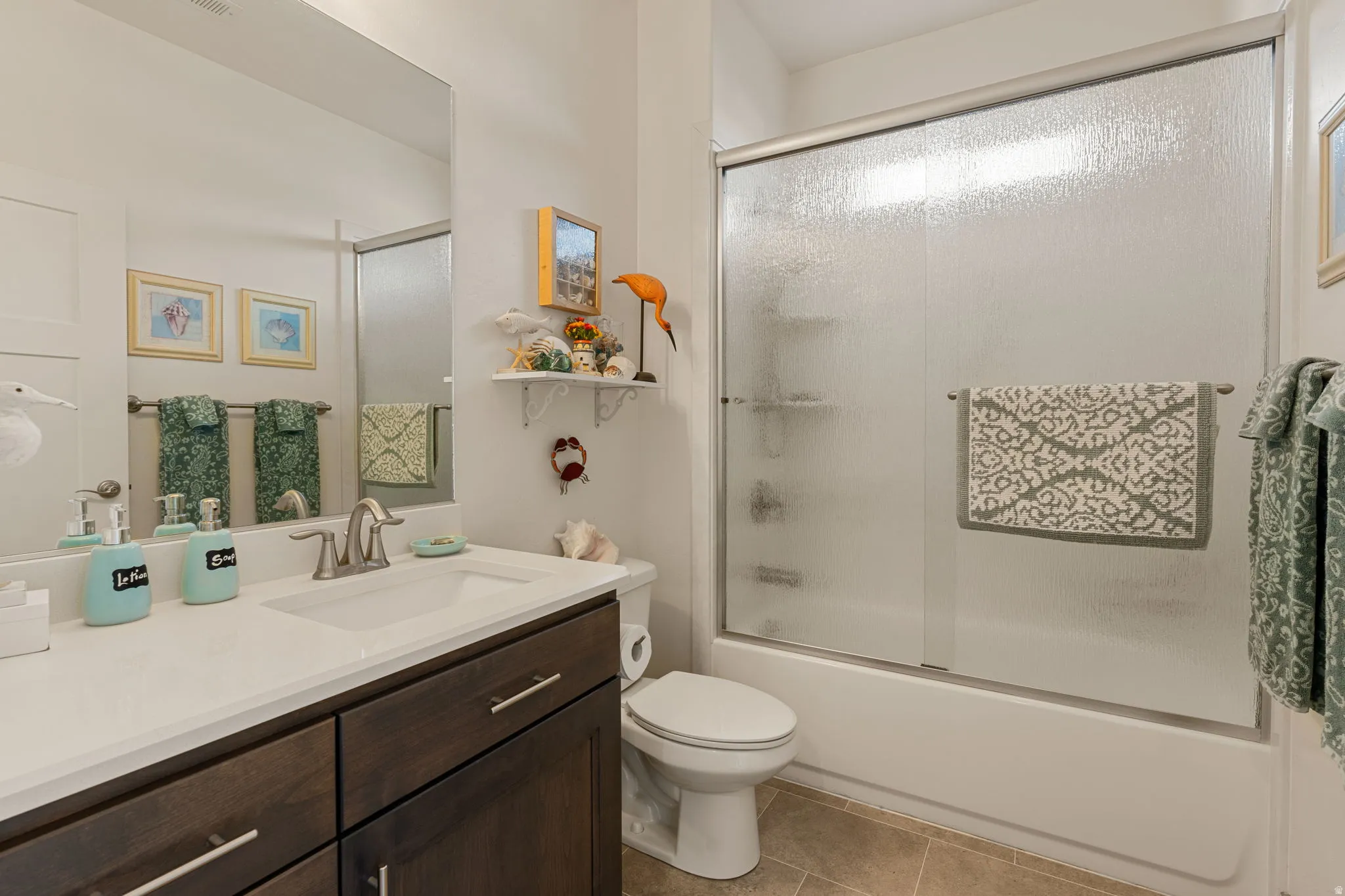 White vanity with a single basin sink, brushed nickel faucet, and integrated dark wood-finish cabinetry