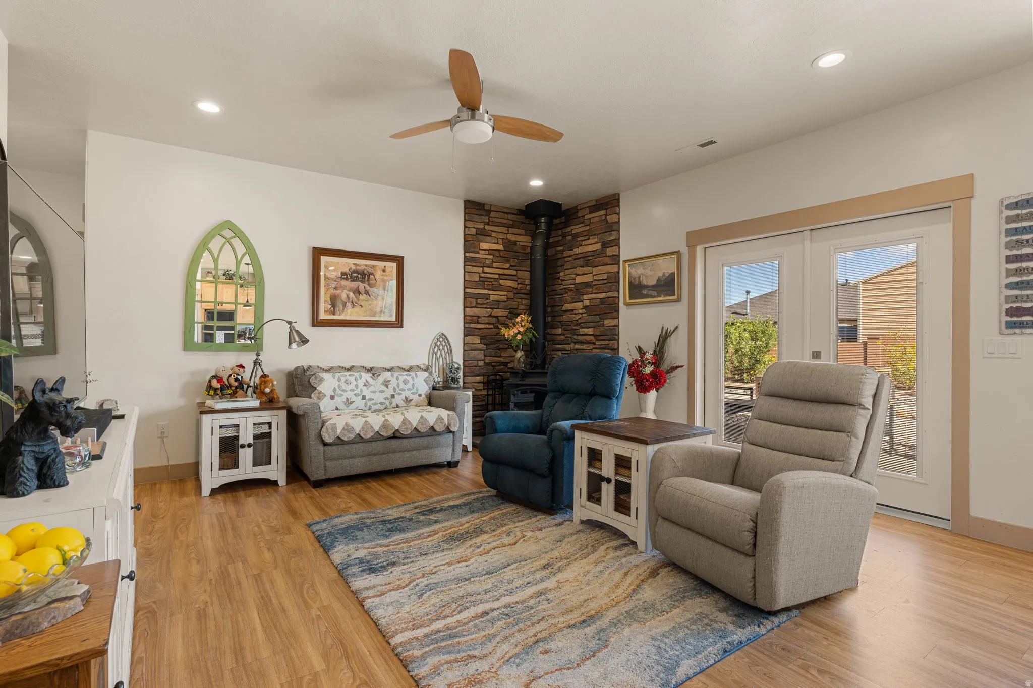 Wood-finish flooring, recessed lighting, and a ceiling fan with light fixture