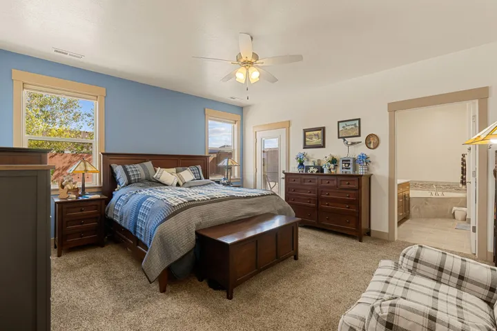 Wall-to-wall carpeting with a ceiling fan, multiple windows, and direct access to a private balcony