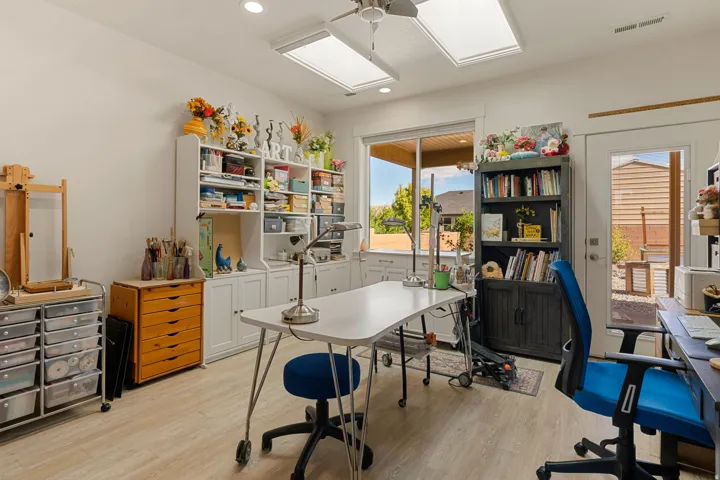 Recessed lighting, skylights, and a ceiling fan create a bright environment