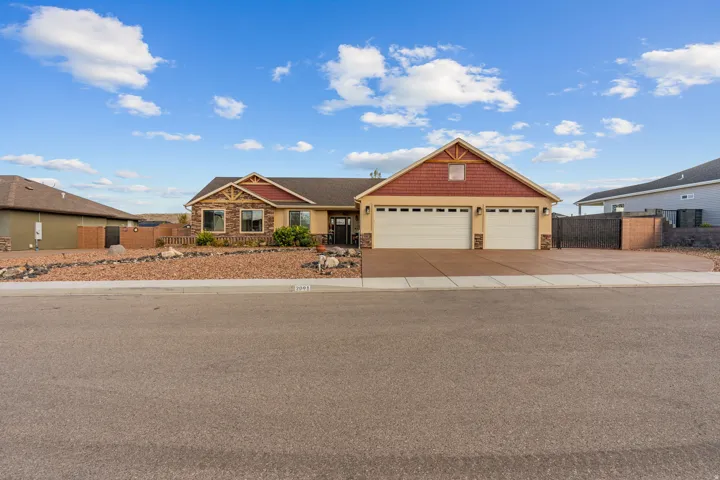 Stucco exterior with stone accents and a prominent two-car garage