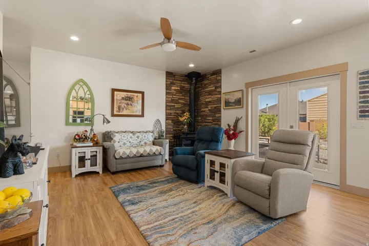 Wood-finish flooring, recessed lighting, and a ceiling fan with light fixture