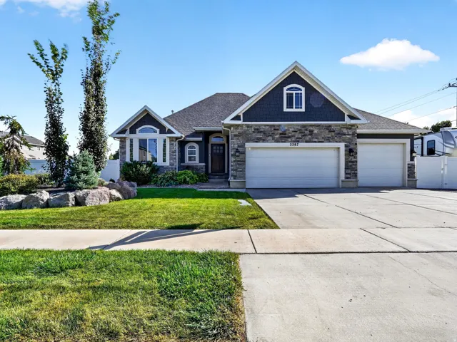 Stone and shake exterior with a multi-car garage