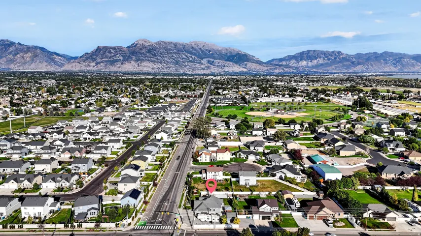 Expansive neighborhood setting with mountain backdrop and established residential properties