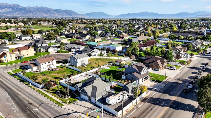 Expansive residential area featuring established homes, mature landscaping, and mountain backdrop