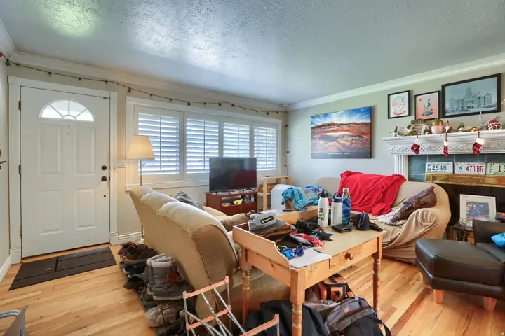 Warm wood-finish flooring complemented by white trim and crown molding