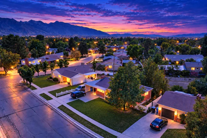 Residential neighborhood with tree-lined streets and mountain backdrop