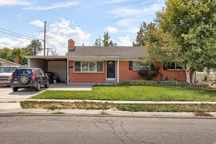 Brick exterior with a covered carport