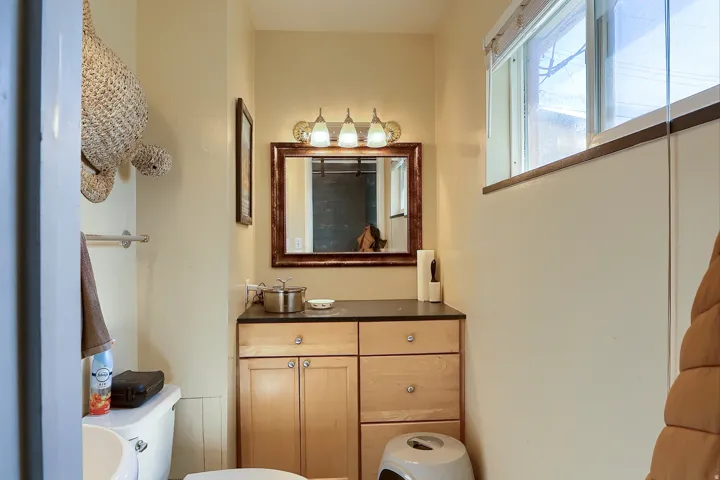 Wood-finish vanity with cabinetry and drawers