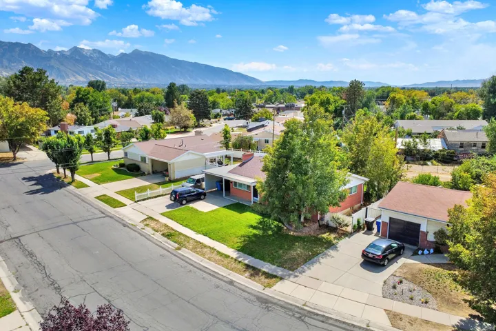 Property with an attached carport, detached garage, and paved driveway