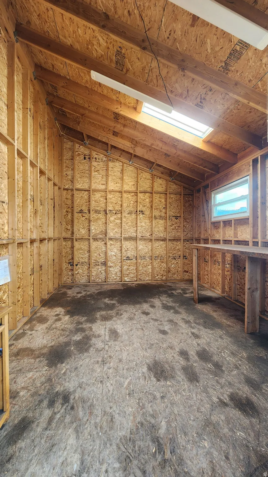 Exposed wood framing and open ceiling beams with an integrated skylight