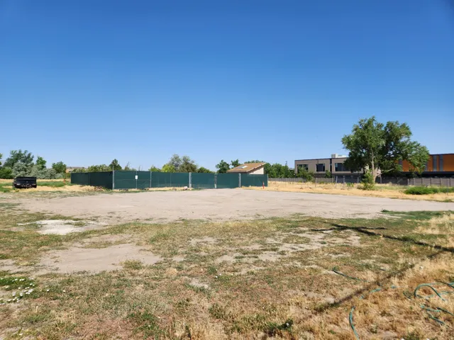 Expansive land parcel featuring open terrain and perimeter fencing
