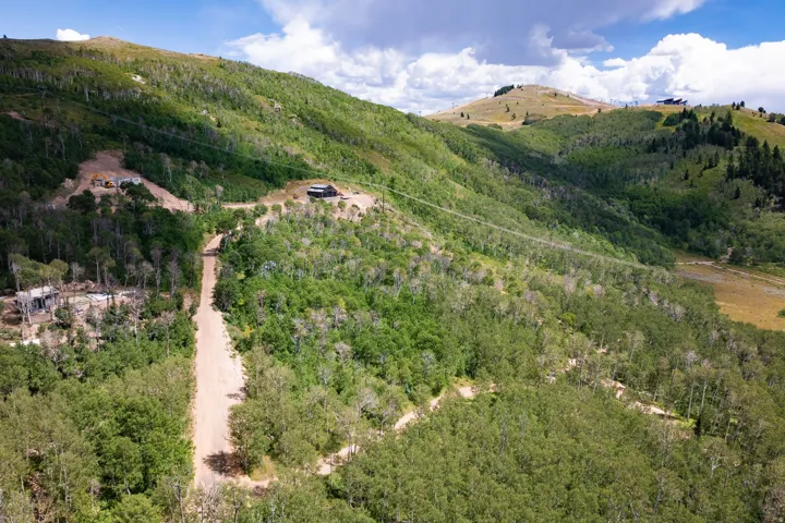 Extensive mountainous terrain featuring verdant trees