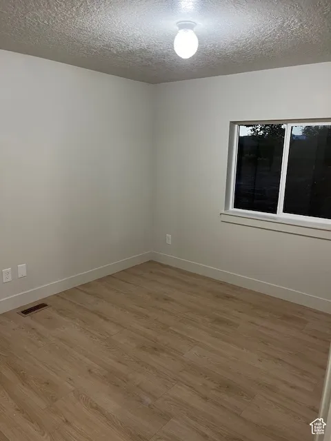 Wood-finish flooring, neutral wall paint, and white trim