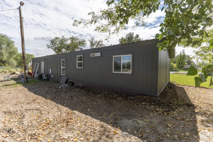 Dark-toned siding, multiple window placements, and a low-profile roofline