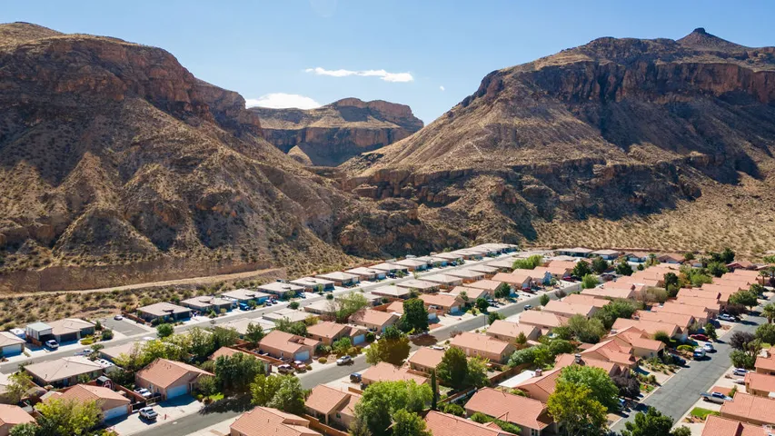 Residential community situated against a prominent mountain backdrop