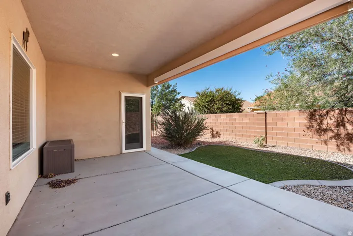 Covered patio with concrete flooring, recessed lighting, and a security screen door