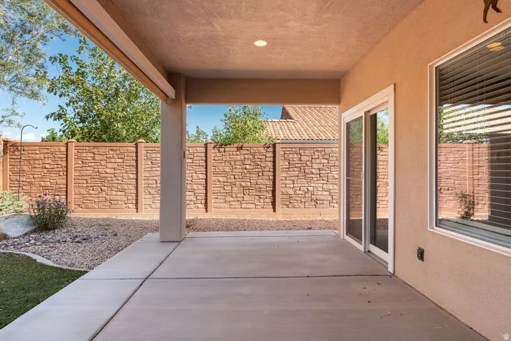 Covered patio with an exterior sliding glass door and an adjacent exterior window