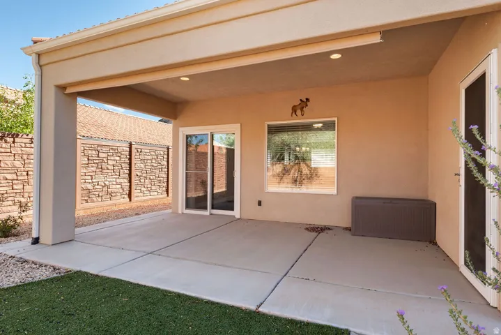 Patio with stucco finish, recessed lighting, and a sliding glass door