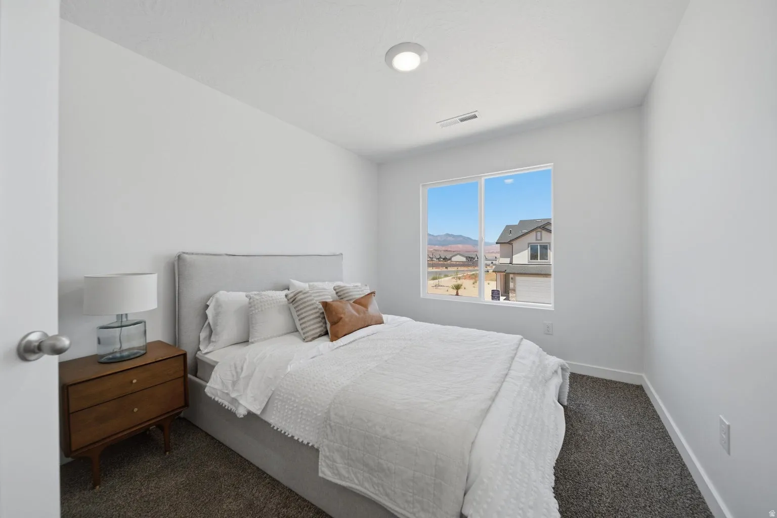Recessed lighting, light-colored walls, large window, and carpeted flooring