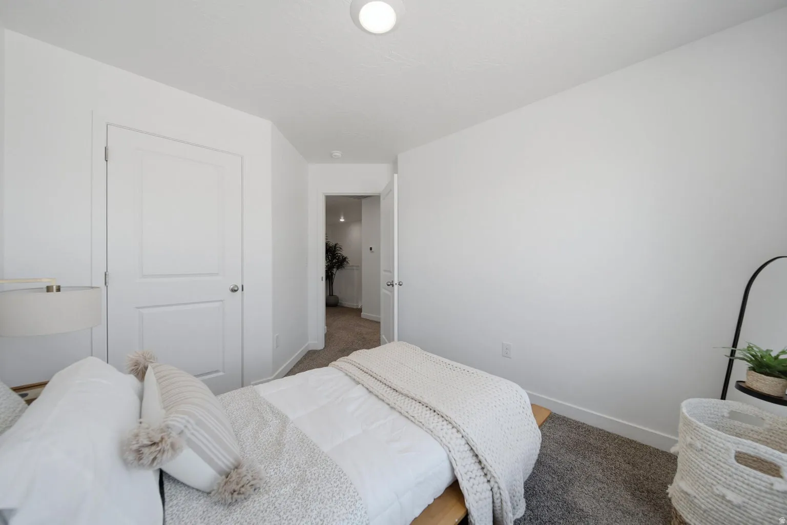 White painted walls with a textured ceiling and recessed lighting