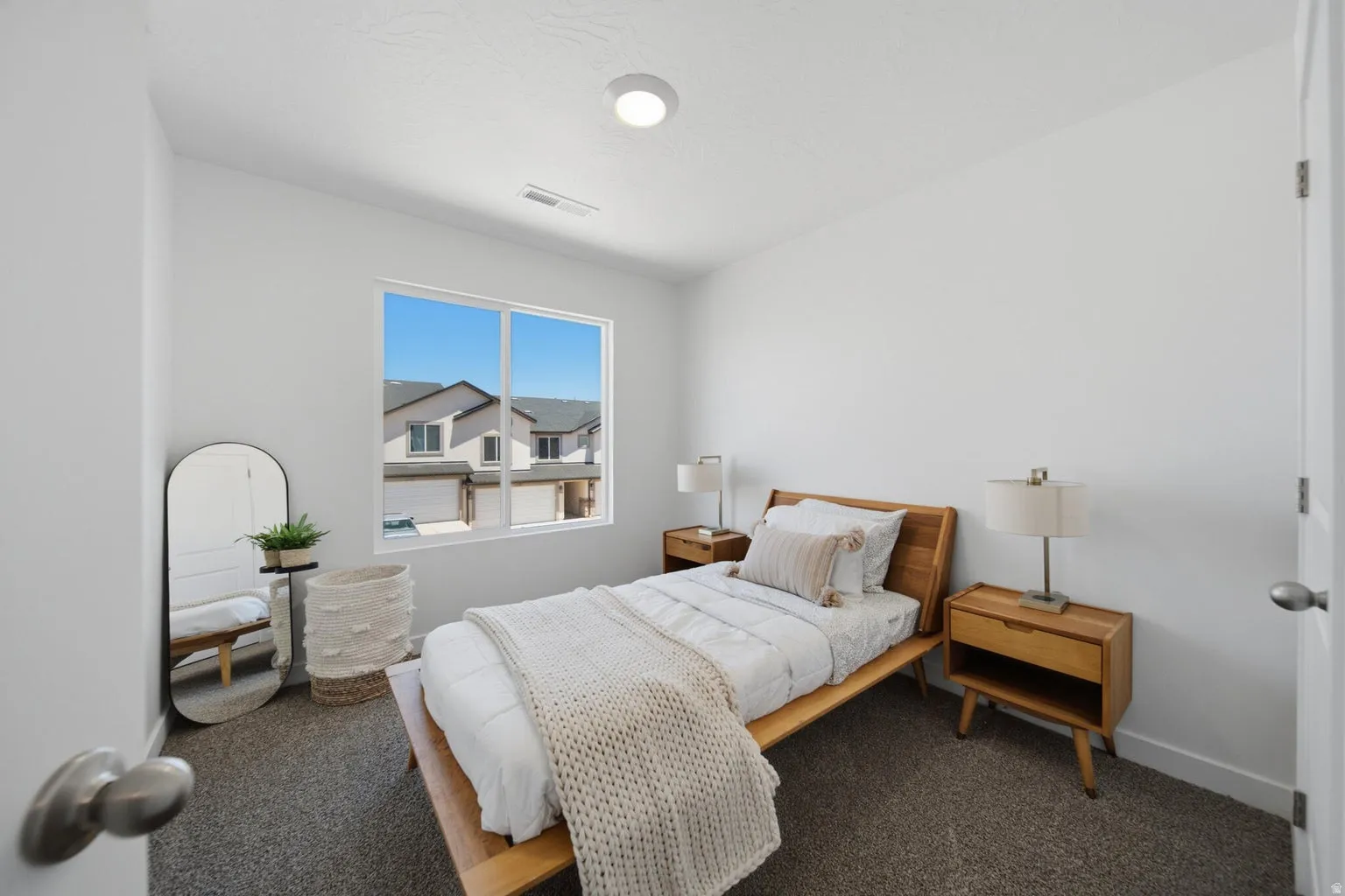 Bright room with a large window, recessed ceiling light, and neutral wall color