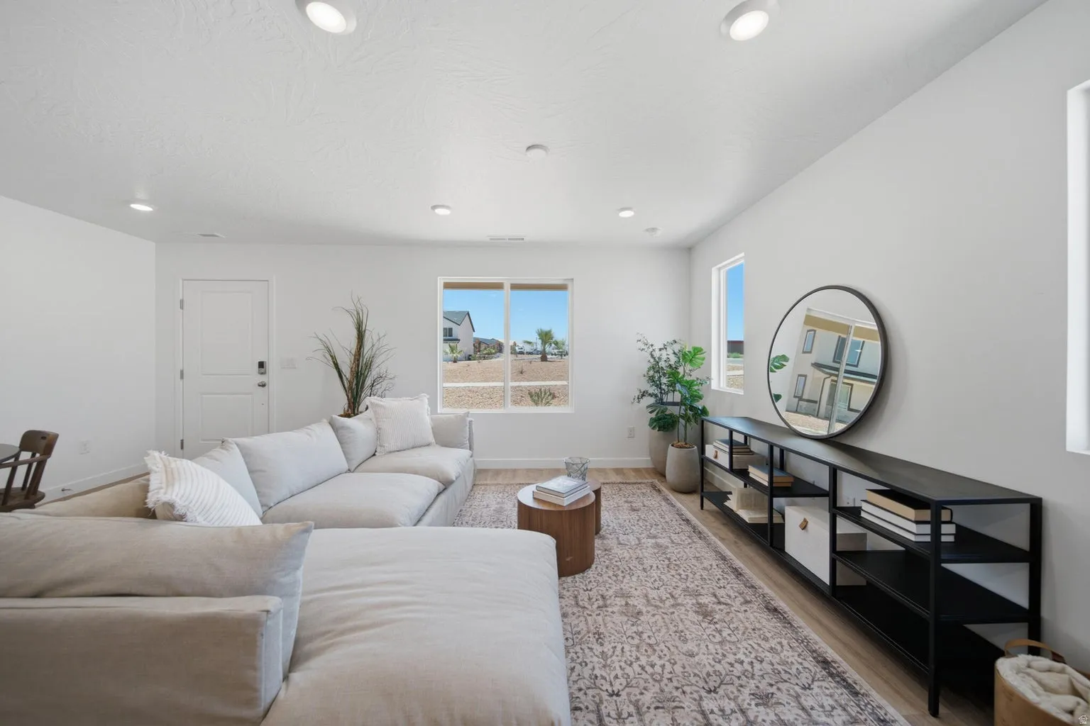 Recessed lighting, wood-finish flooring, white walls, and multiple windows