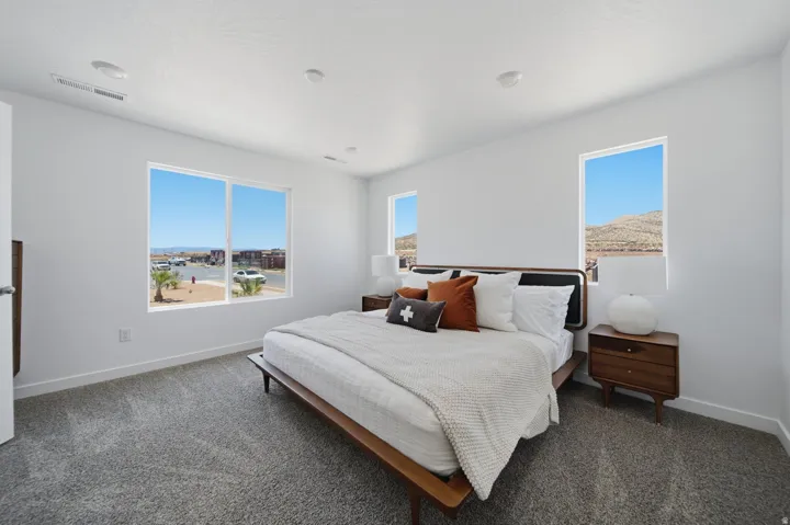 White interior walls with recessed lighting and gray carpeting