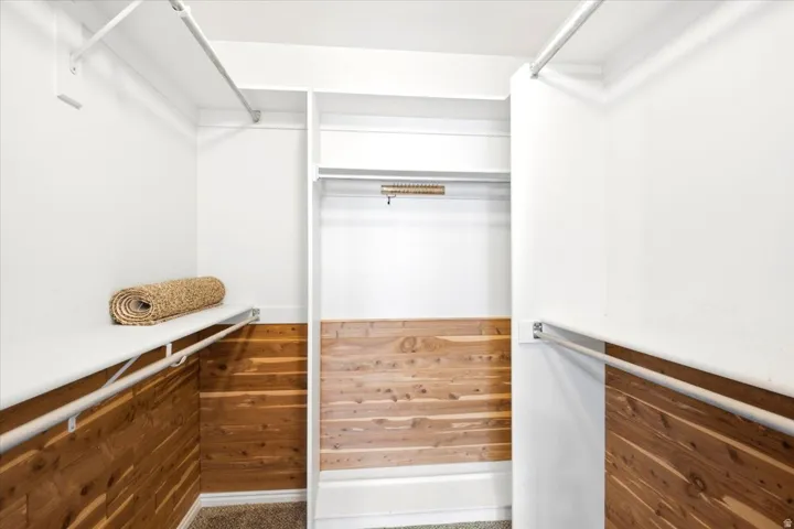 Built-in custom shelving, integrated hanging rods, and wood paneling