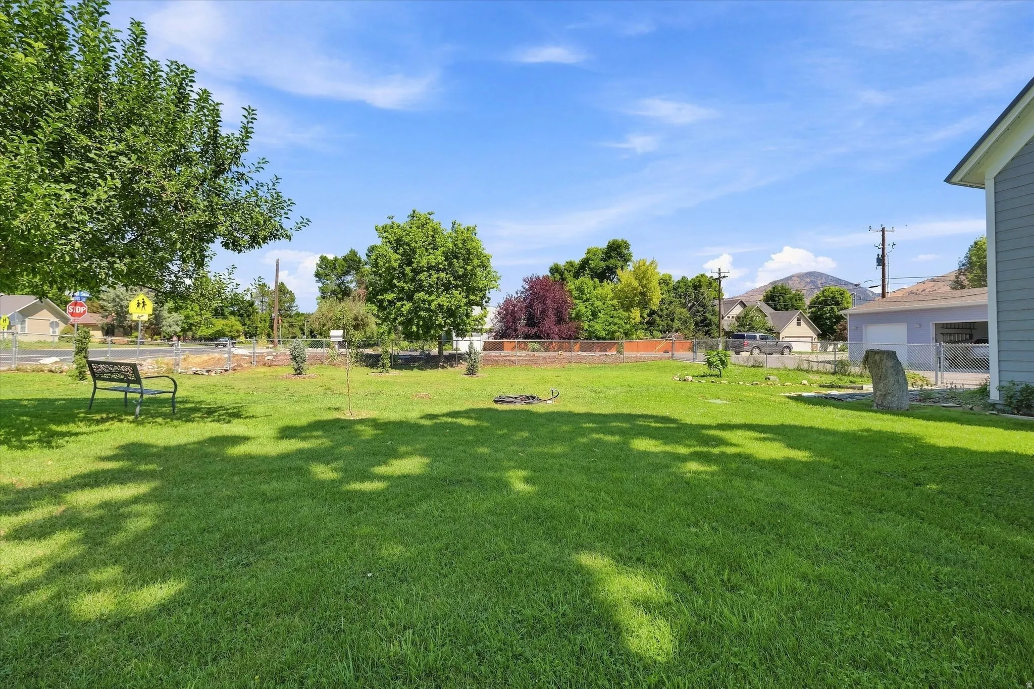 Expansive lawn with scattered trees and mature landscaping