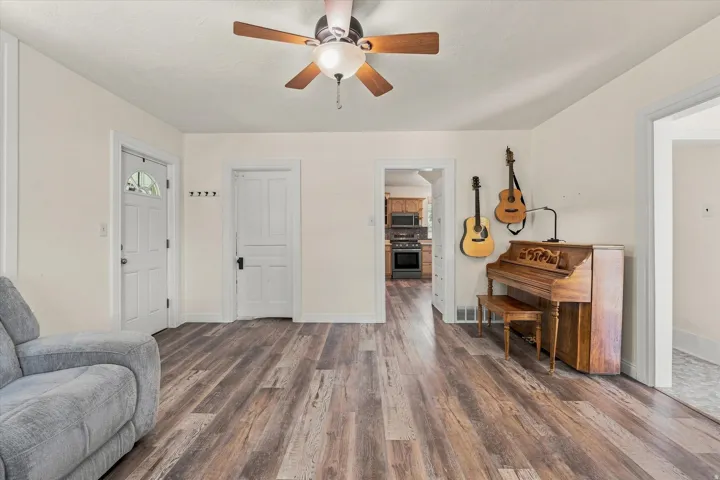 Wood-finish flooring throughout, complemented by a ceiling fan with integrated lighting