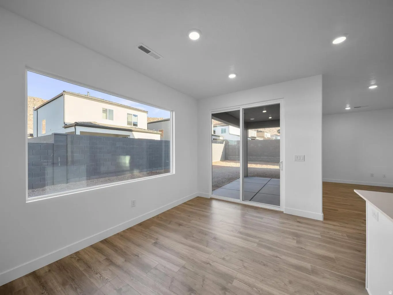 Wood-finish flooring, recessed lighting, and a large picture window
