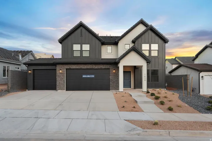 Contemporary two-story exterior with board and batten siding, stone facade accents, and a covered entry