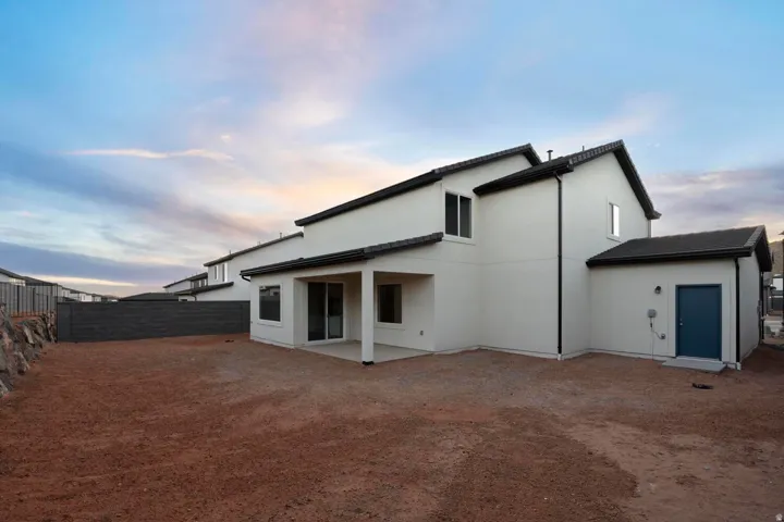 Modern stucco exterior with dark trim and a covered patio