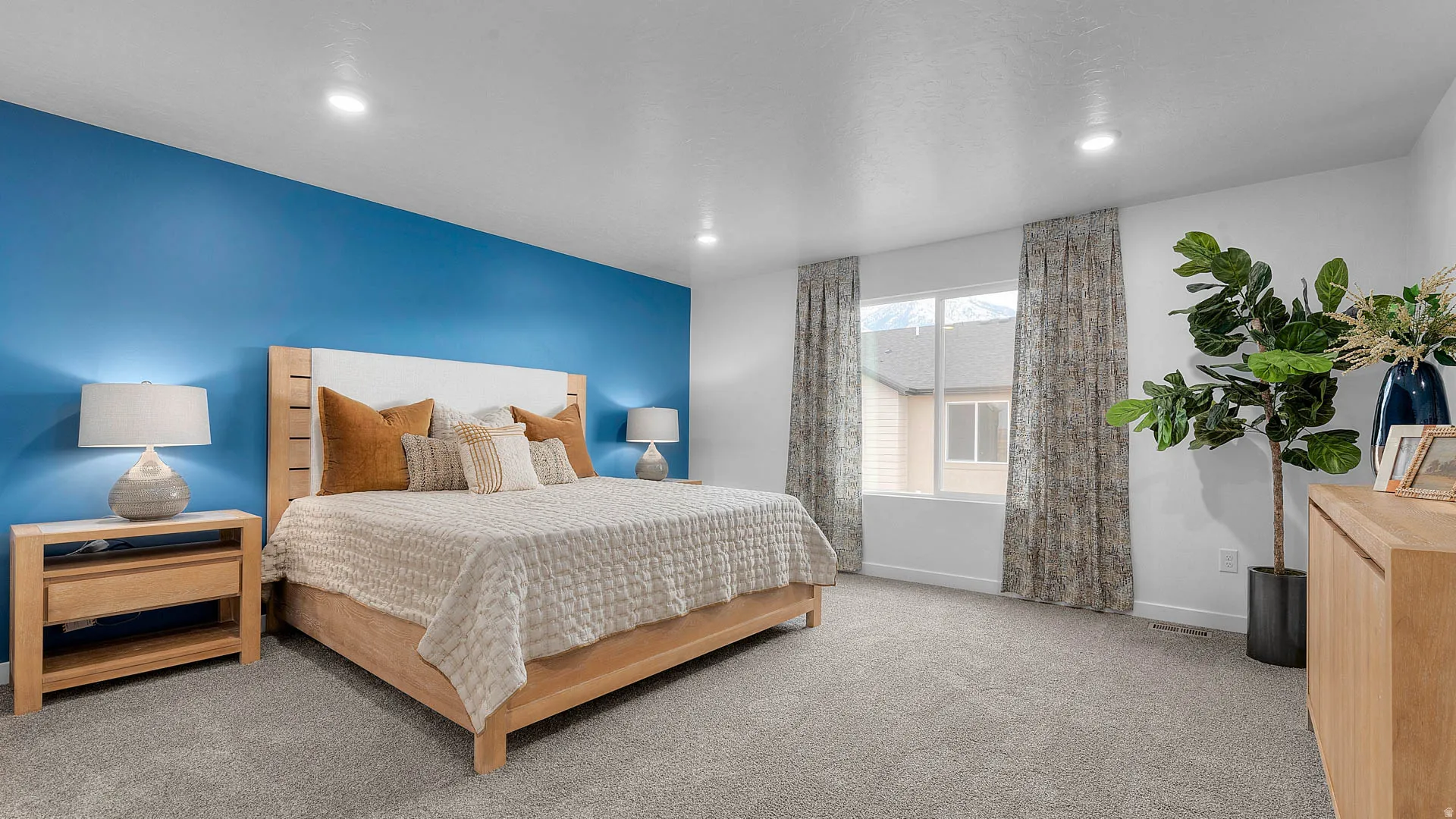 Spacious room featuring plush carpeting, a large window, and recessed lighting