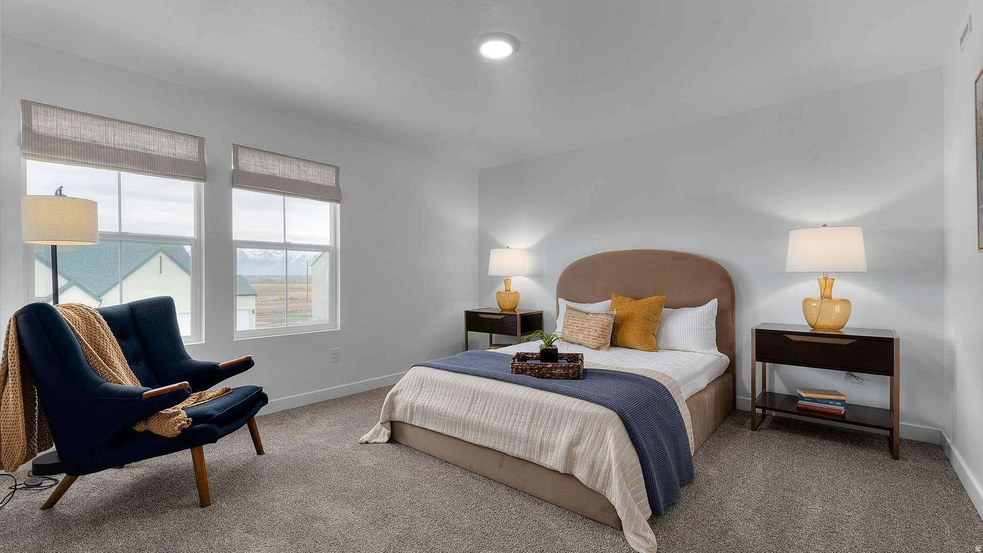 White walls with recessed lighting, complemented by light gray carpeting