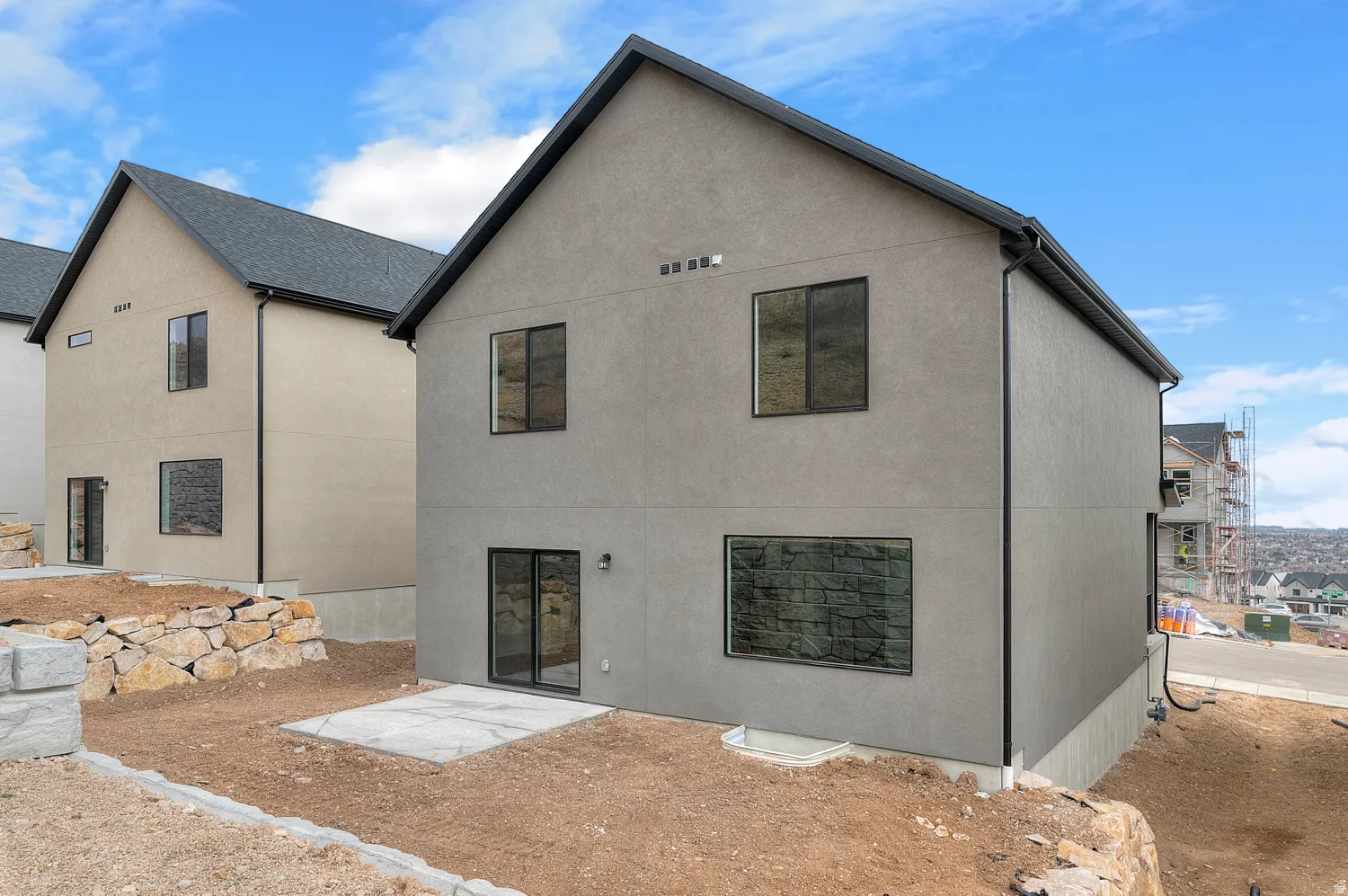 Modern stucco exterior with a gray tone and black-framed windows