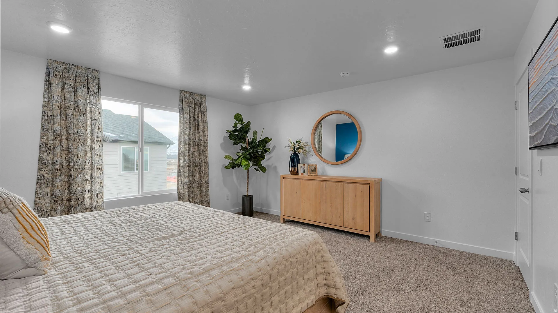 Recessed lighting, white walls, and a large window