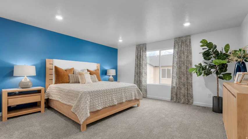 Spacious room featuring plush carpeting, a large window, and recessed lighting