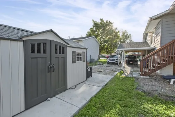 Freestanding storage shed with double doors, side window with shutters