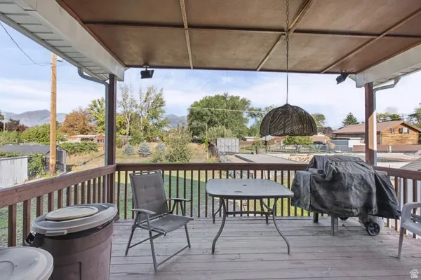 Covered outdoor deck with wood-finish railing and decking