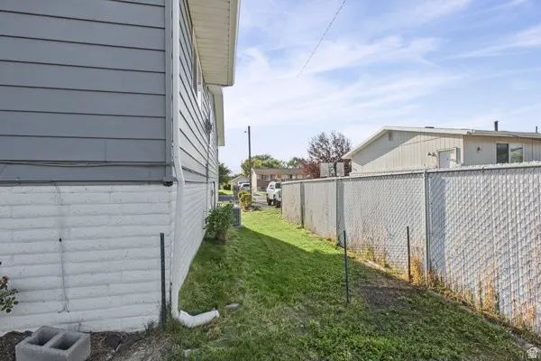 Exterior siding in a gray finish, white painted brick foundation