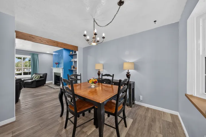 Wood-finish flooring throughout, with a decorative ceiling light fixture