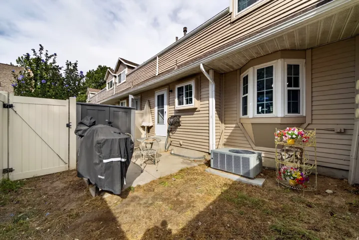 Exterior features include a private patio, a bay window, and tan siding