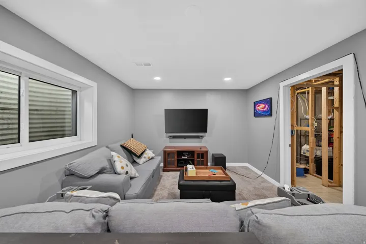 Carpeted flooring, recessed lighting, and a white-trimmed window